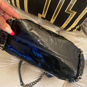 MCM patten leather tote back with silver chain strap. In excellent condition